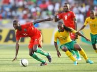 Robin Ngalande of Malawi (l) outpaces South Africa's Renielwe Letsholonyane in a friendly on December 22, 2012 in Durban